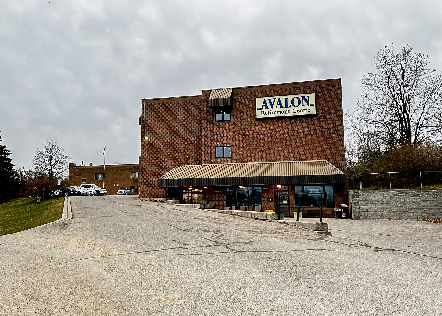 A brick building with a parking lot. The Avalon retirement lodge and long-term care facility in Orangeville.